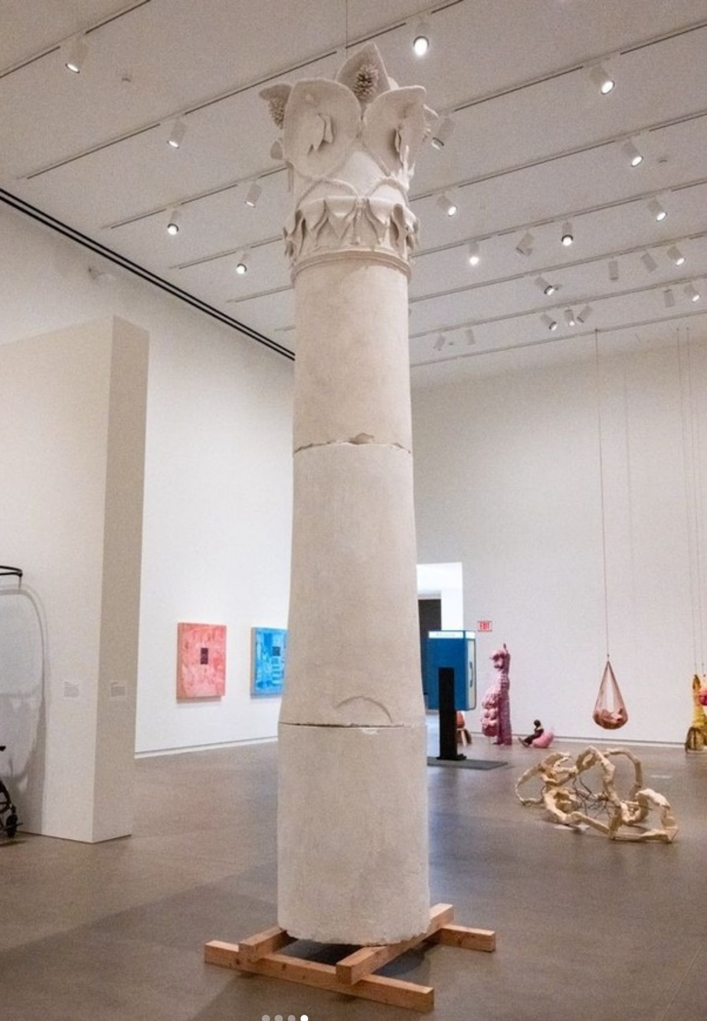 tall plaster column with detail scrolls near the top