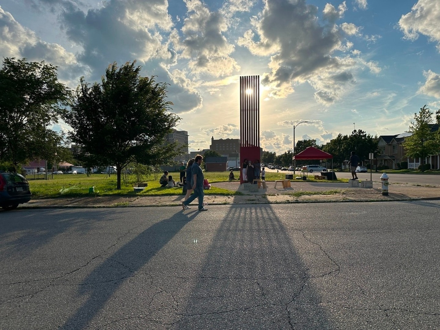 tall red sculpture in a park 