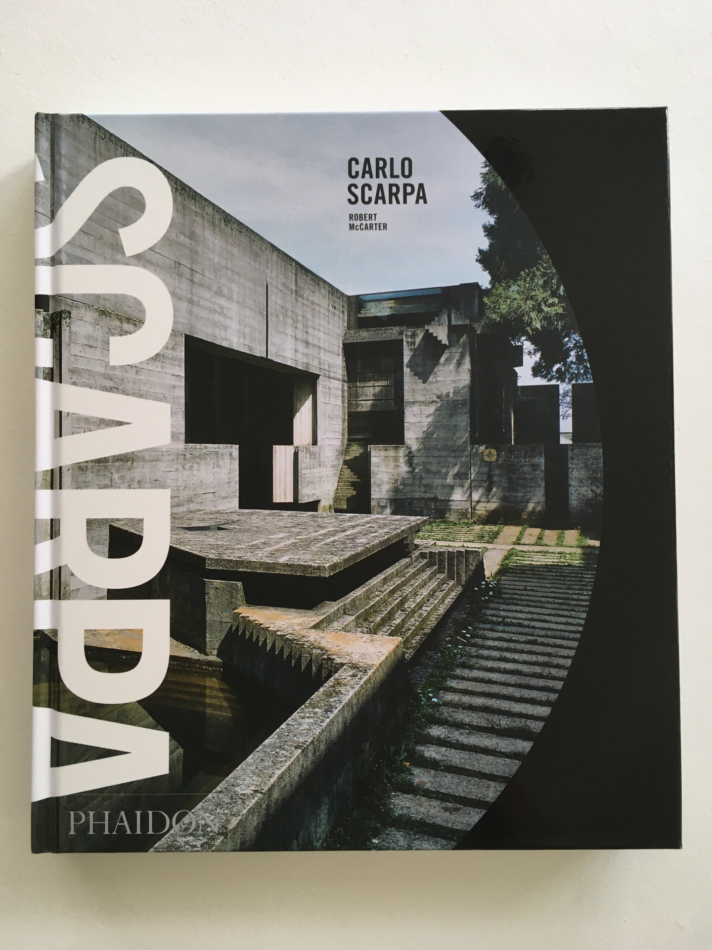 Cover of Carlo Scarpa, featuring an exterior photo of a walkway leading to a stone building.