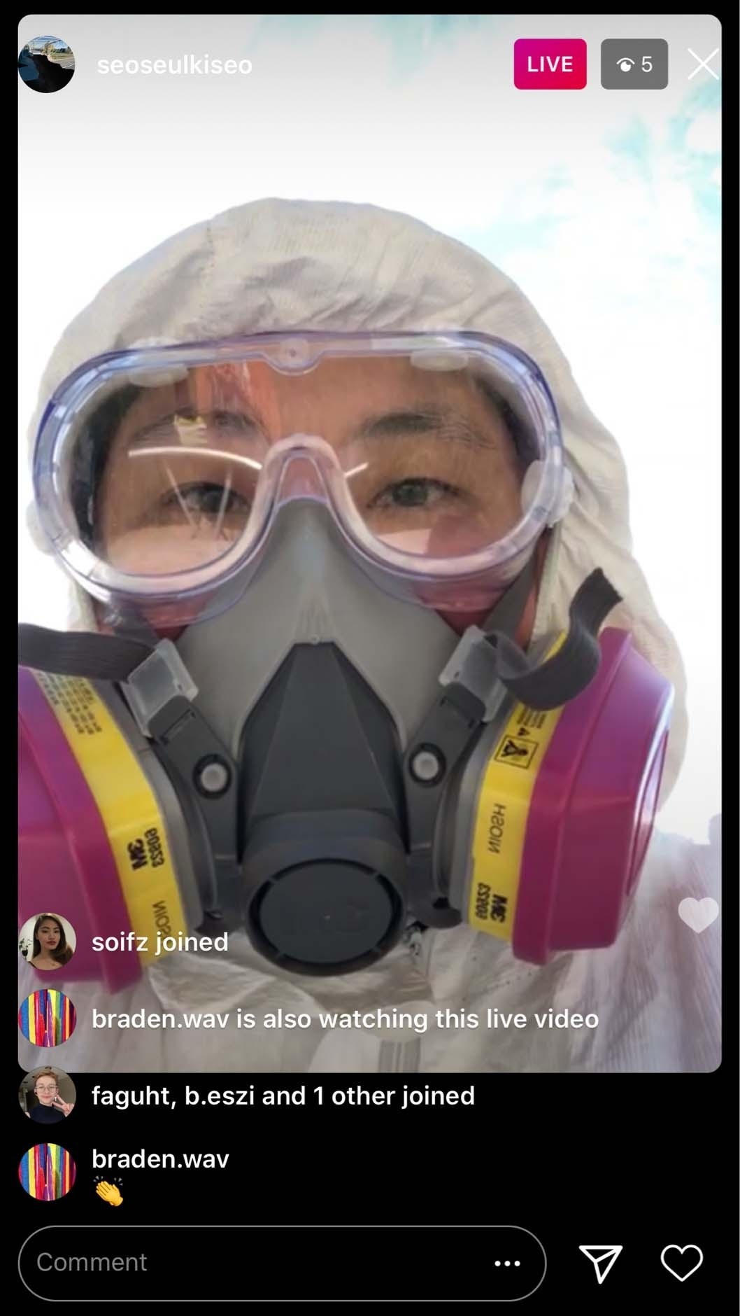 An instagram live screenshot view with Seulki looking at the camera in full Personal Protective Equipment 