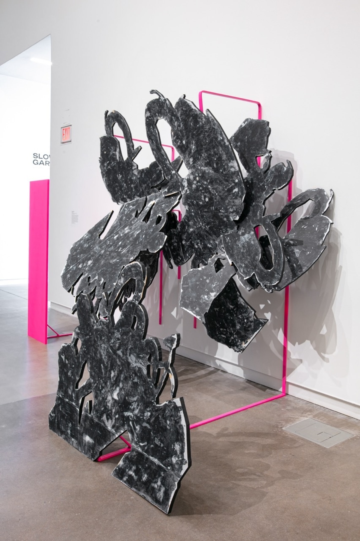 large abstract sculpture in grays and neon pink