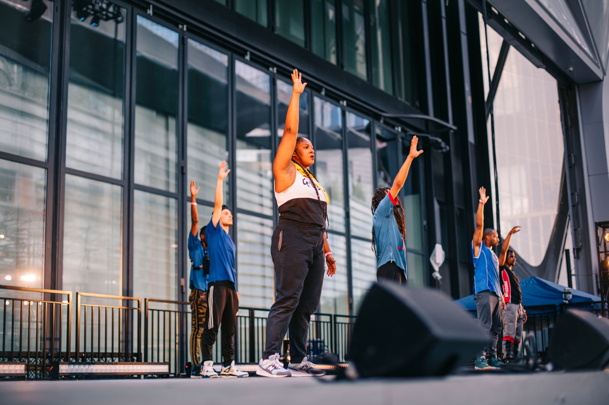 A group of dancers in motion on a stage.