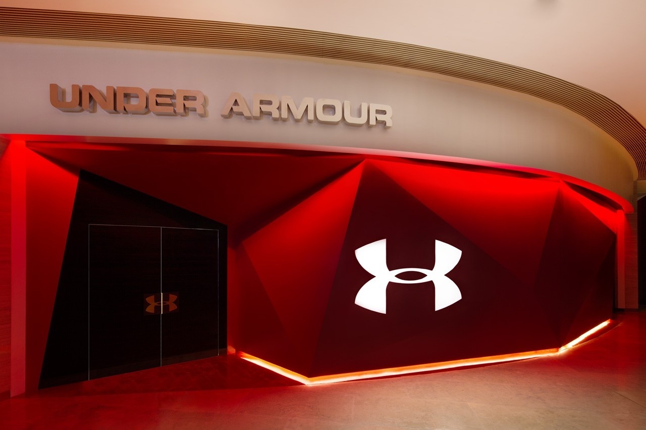 Exterior design of retail brand experience, of an angular, polygonal red surface and the Under Armour logo