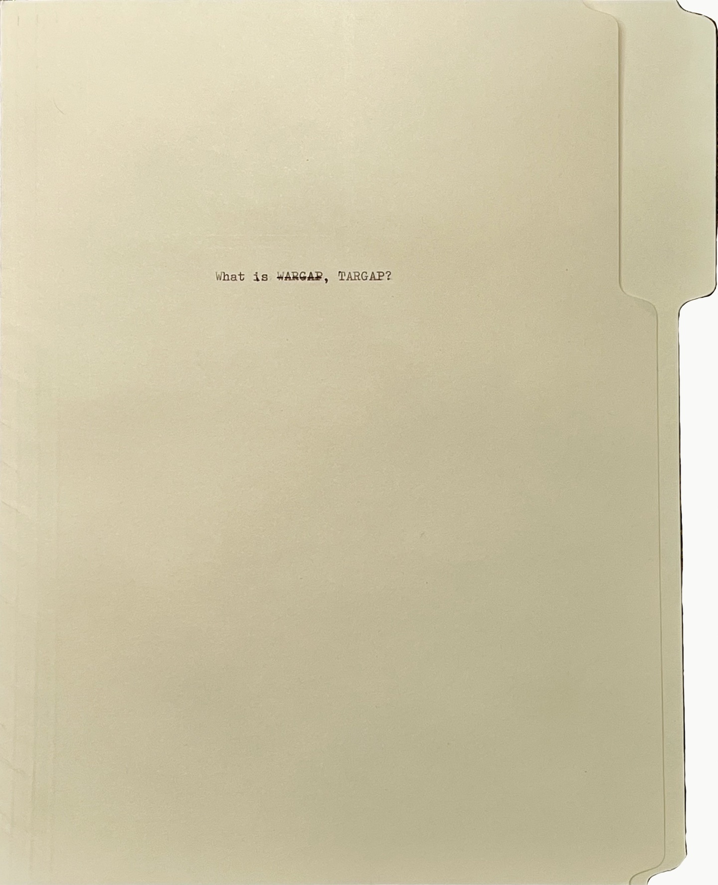 A manila folder on its side, with small, typewriter-written text that says "What is WARGAP, TARGAP?" The word WARGRAP is set in strikethrough type.