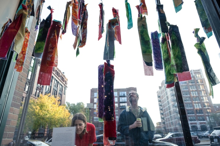 Allena Brazier's artwork of hanging pieces of multicolored cloth at the Des Lee window display