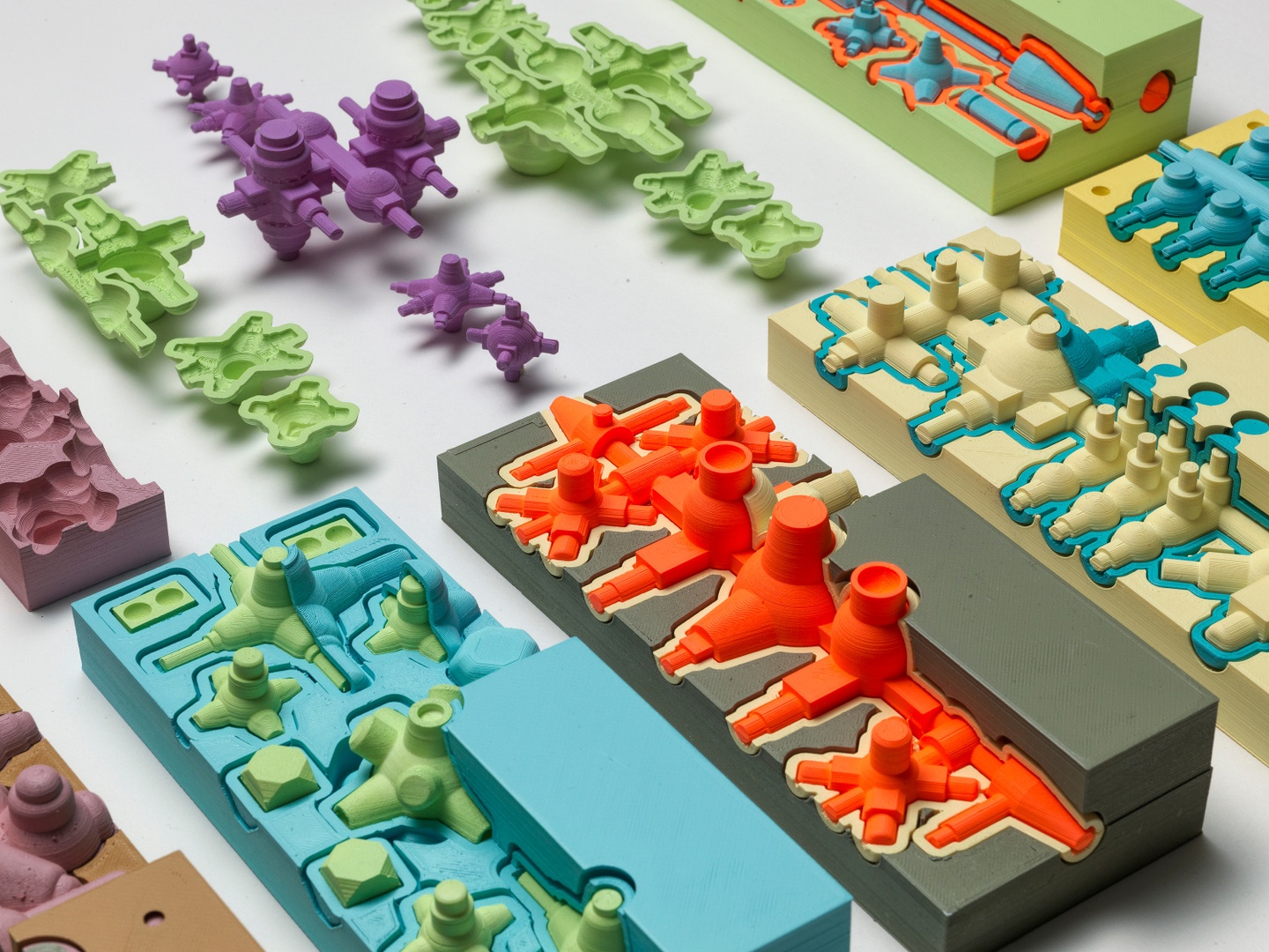 Abstract, brightly colored, 3D printed objects arranged on a white background