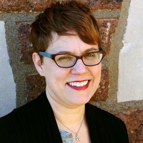 headshot of Heidi Aronson Kolk against brick wall