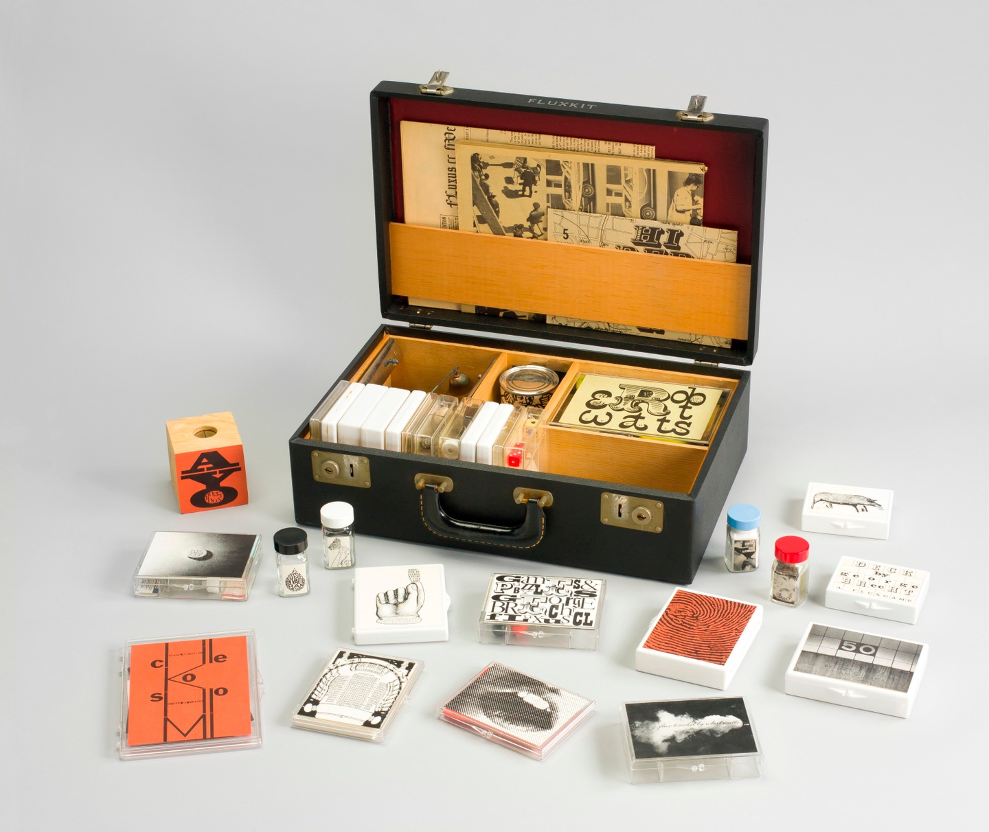 Vinyl attaché case containing objects in various mediums.