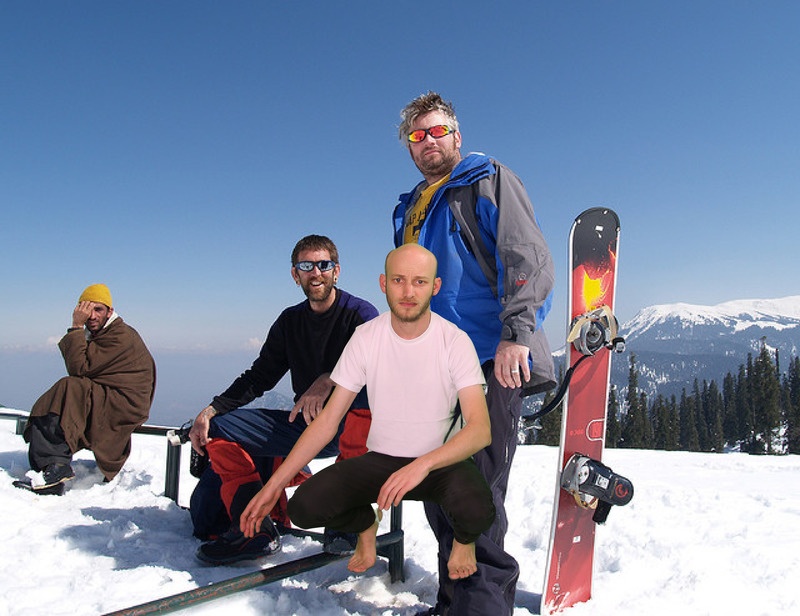 A photo from Sam Lavigne's Open Call commission Training Poses depicting A few people sitting at the top of a mountain with a variety of snow gear on