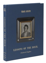 The front cover of Lessons of the Hour at an angle; the front cover is blue with a photo of a dark-skinned man and gold lettering.