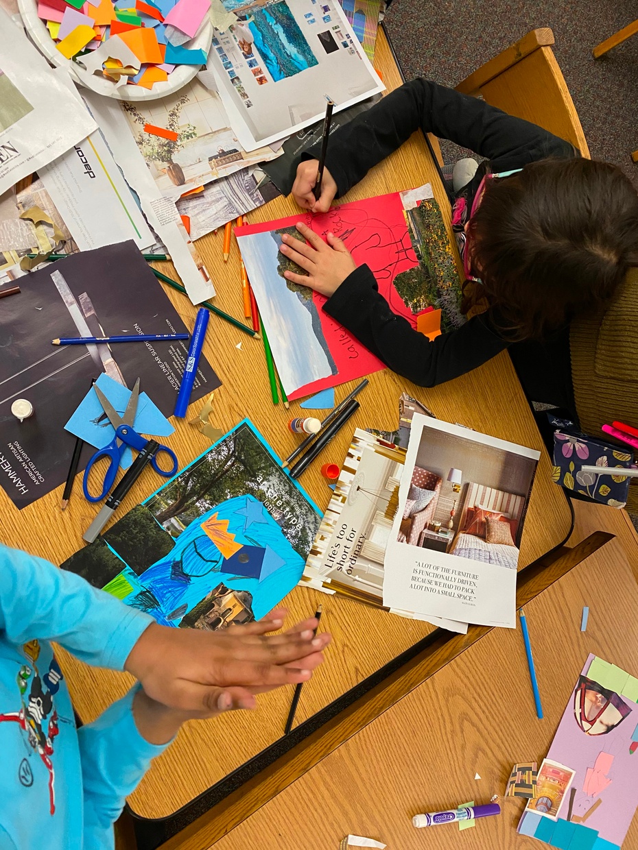 Students working at a desk making collages from magazines.