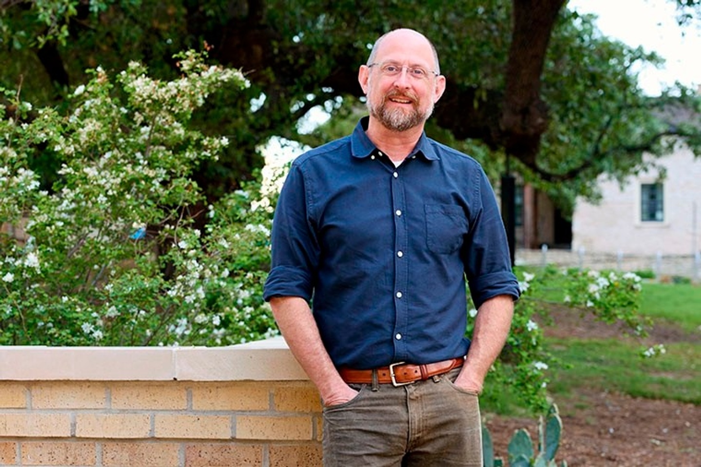 photo of Brendan Wittstruck wearing a blue button down shirt standing against a wall