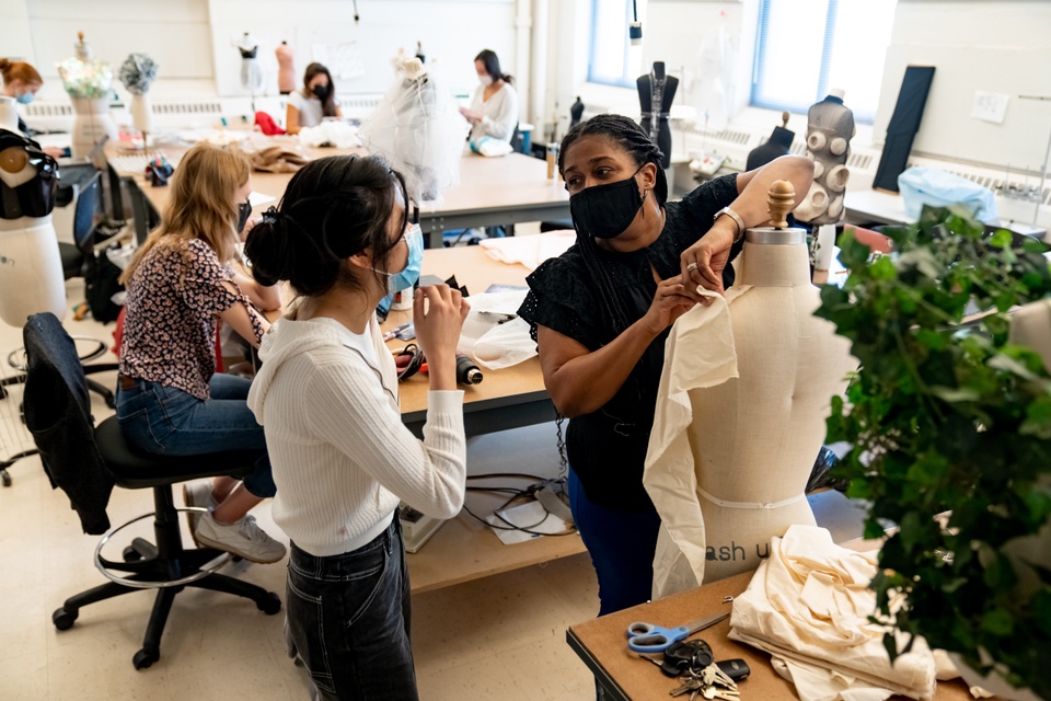 Open workspace with large work tables and fashion mannequins and lots of natural light.