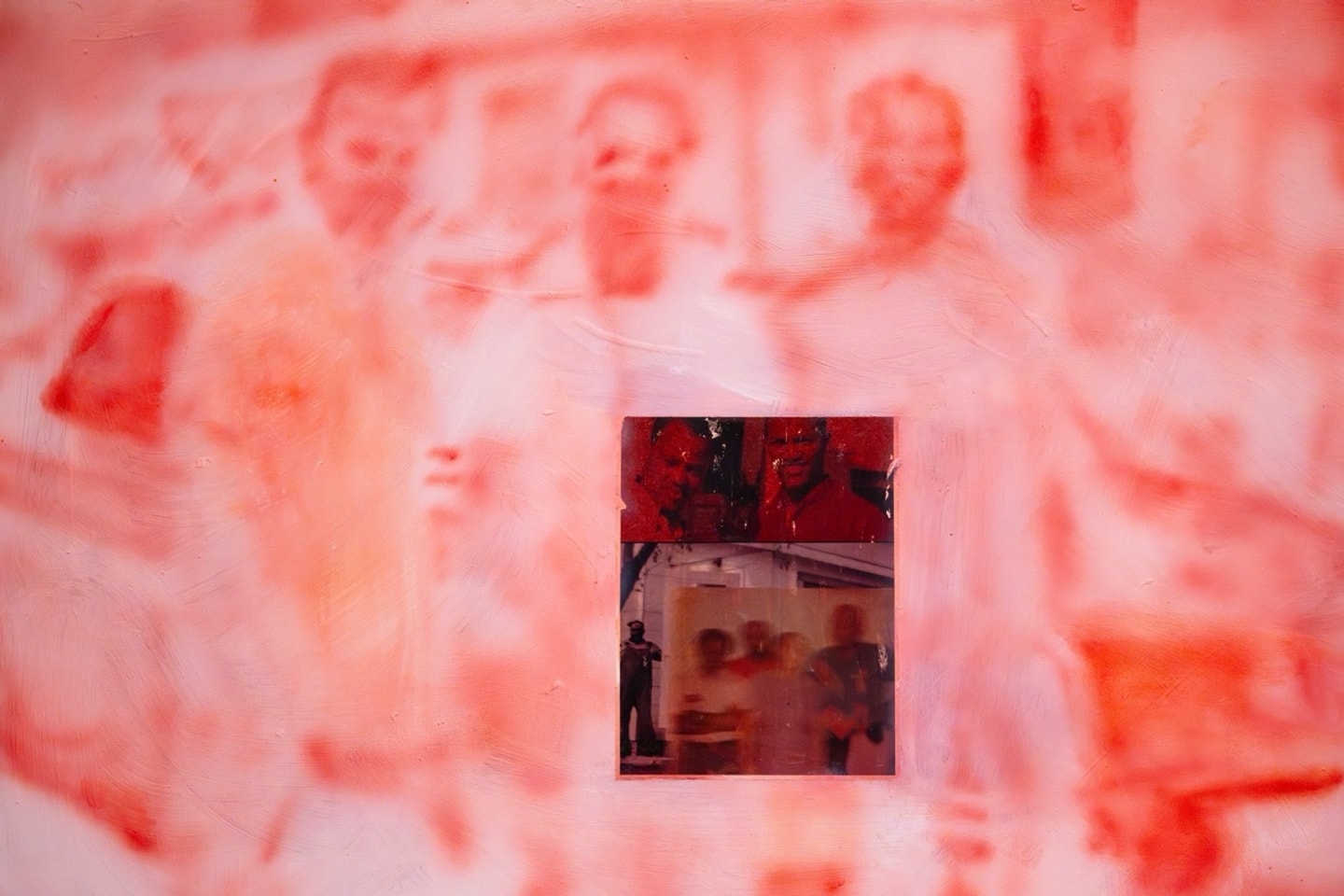 a pink panel and a blue panel with ink over black and white prints of people 