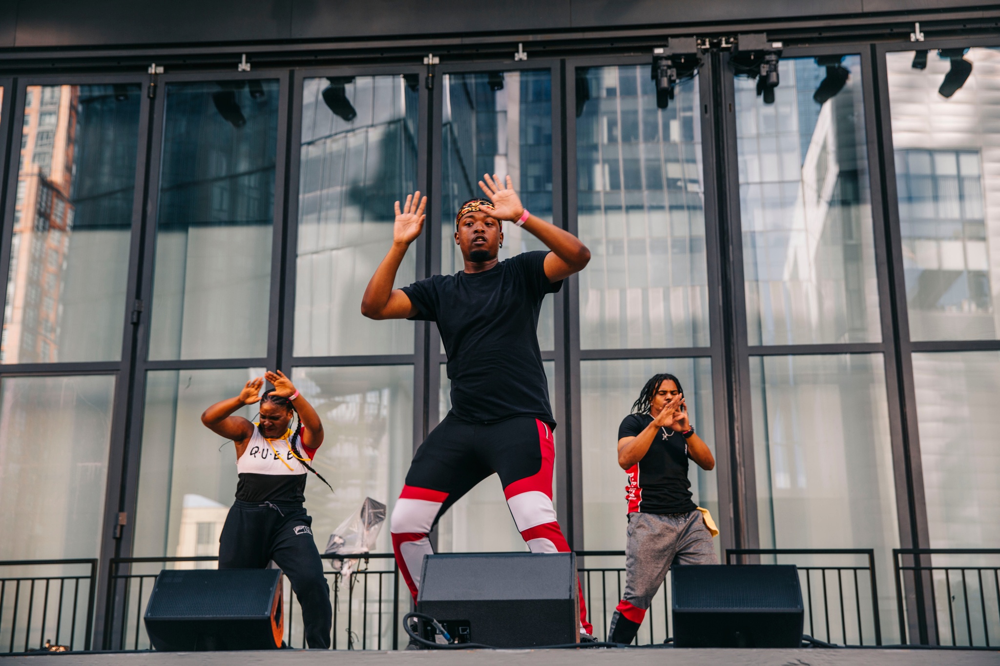 A group of dancers in motion on a stage.