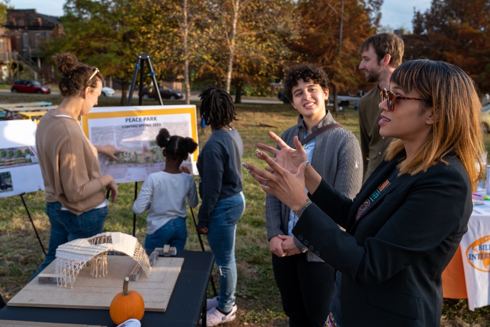 Architecture students and community members talking with people looking at architectural renderings.