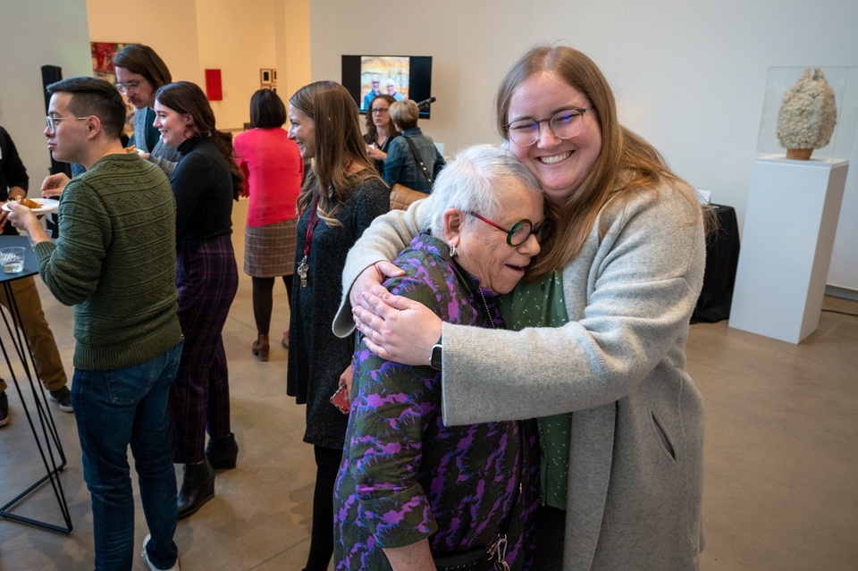 A student gives Georgia a bear hug.