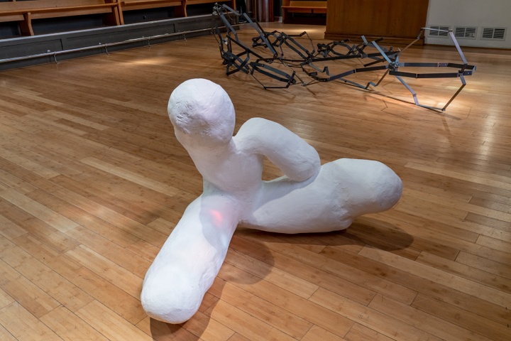 White plaster sculpture with four amorphous rounded appendages.