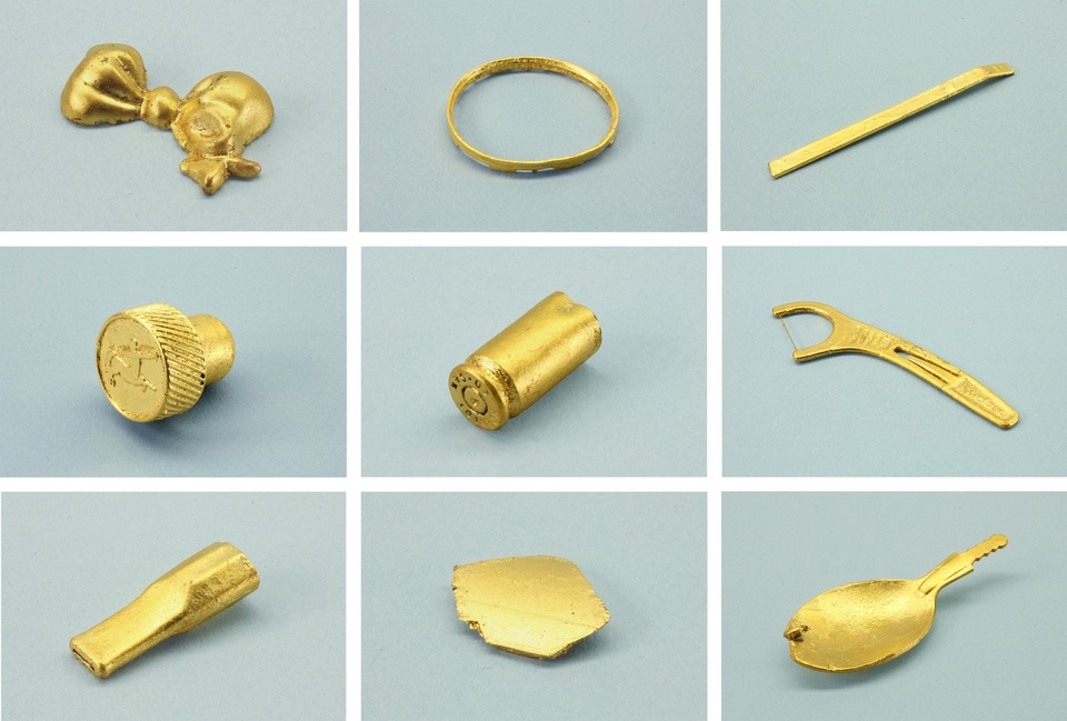 Grid of nine small, gold-dipped objects, each on a gray background.