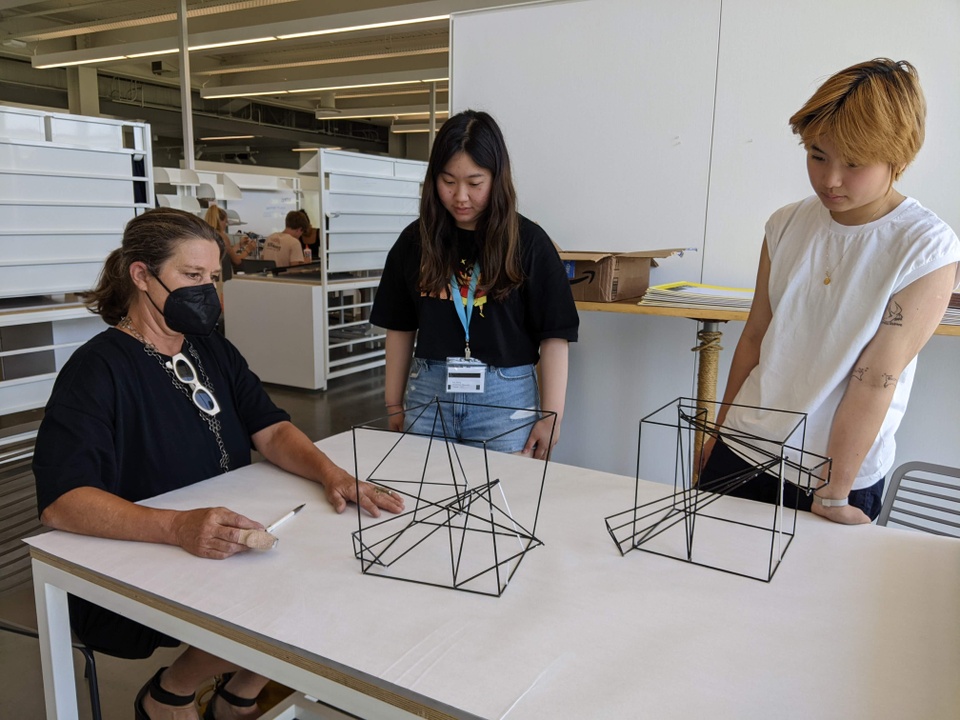 Students present their geometric wire frame work to an instructor