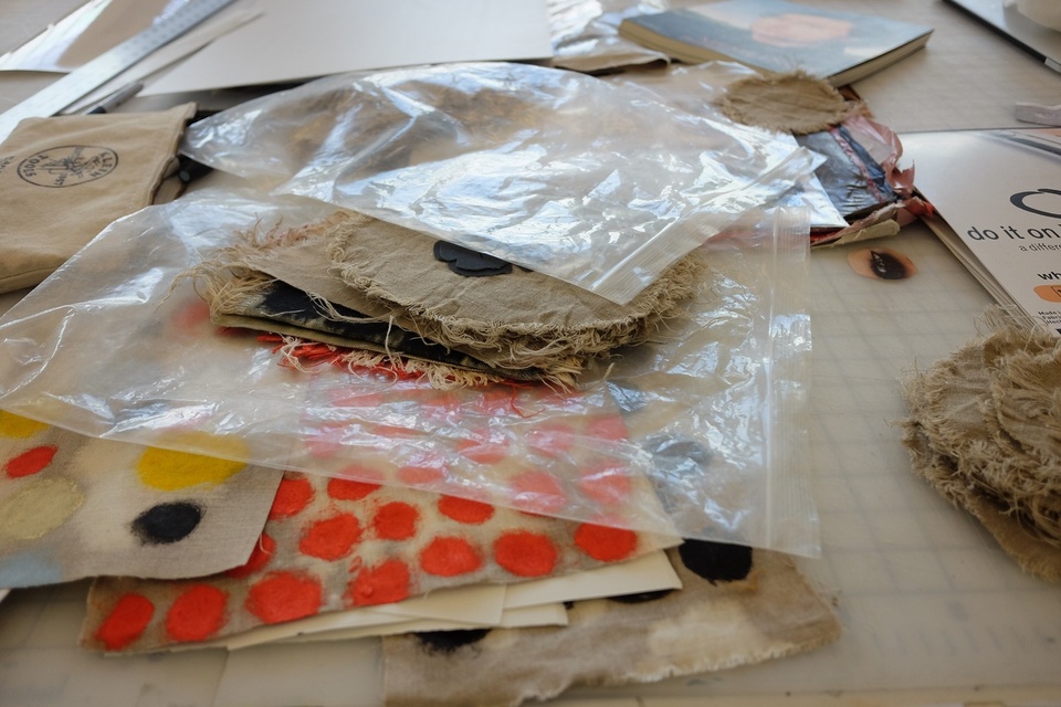 Piles of collage material in plastic bags