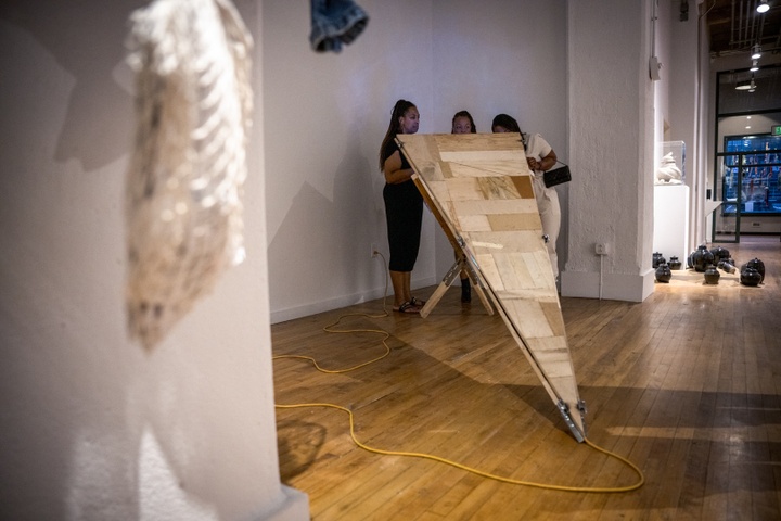 Wide view of Alex Davis' triangular wooden sculpture