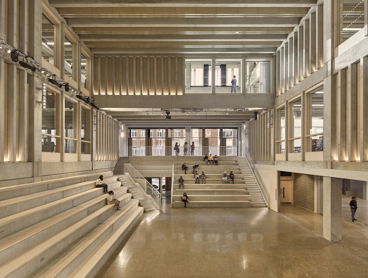 Interior perspective of a two-story building, with lots of vertical beams and single-level stairs on the left and back wall.