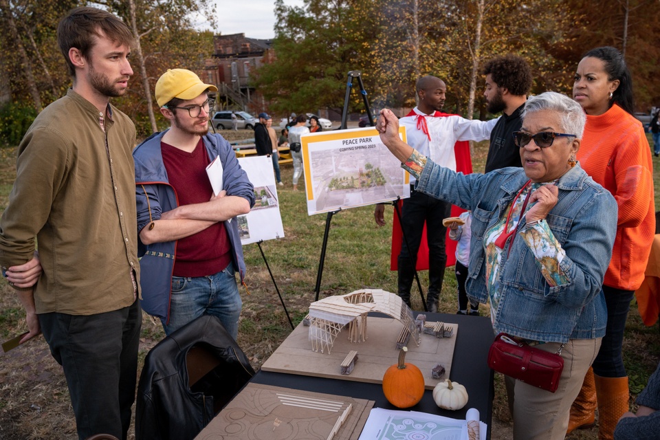 Architecture students and community members talking.