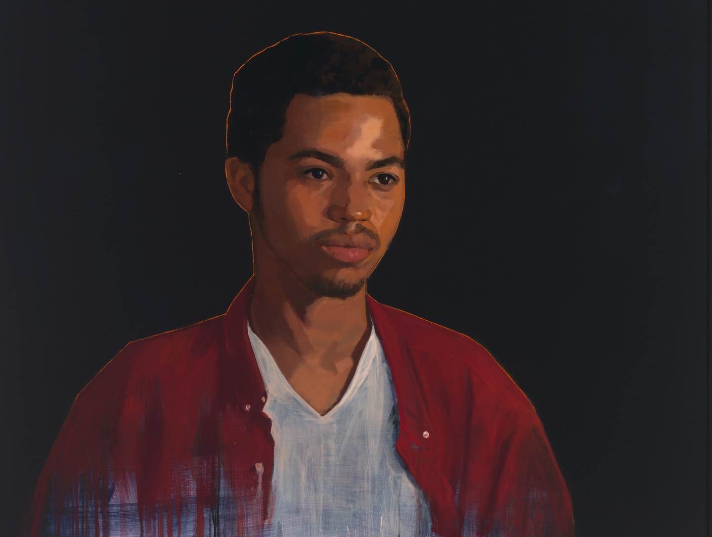 Portrait of a young man against a dark background