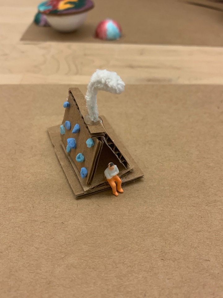 A model of a playground made from cardboard, clay, and other materials.