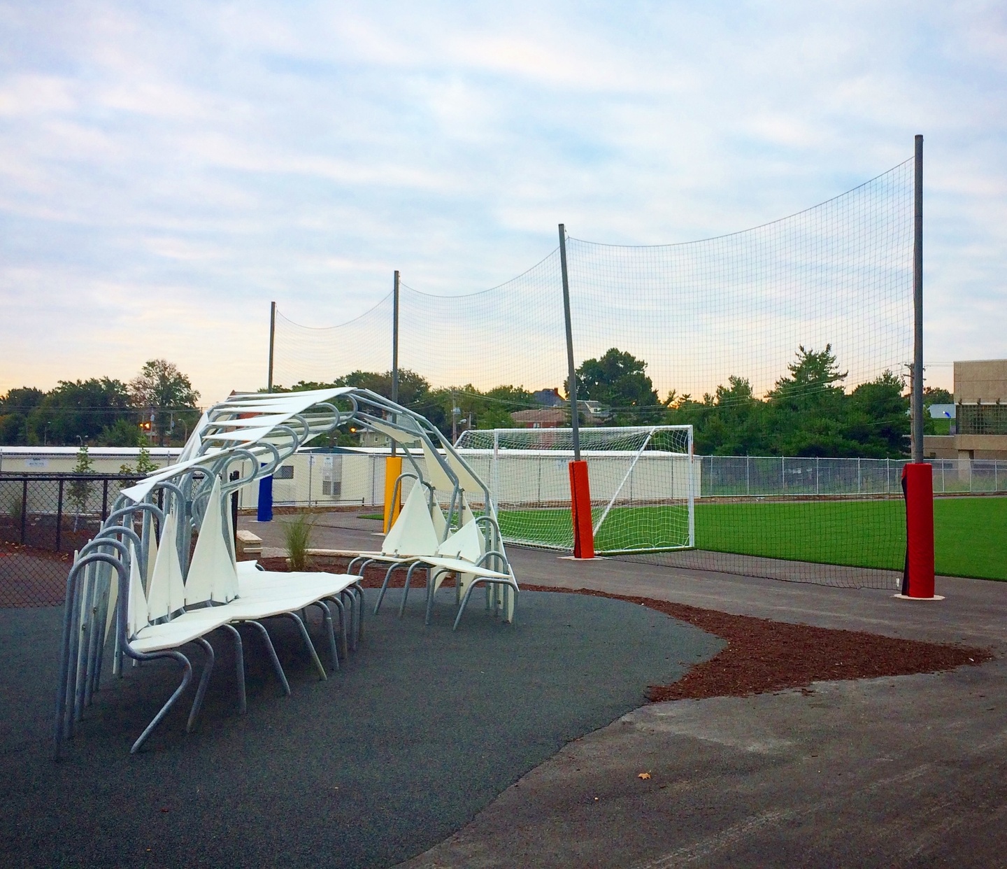 A white and metal seating structure sits in the foreground of a soccer field.