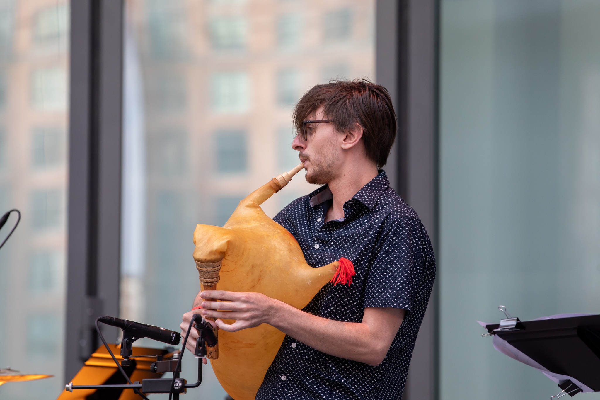 Man playing live instruments on a stage.