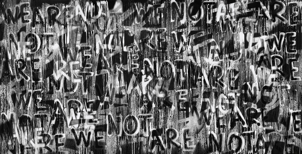 A black-and-white composition with the words "We are not" in different shades throughout