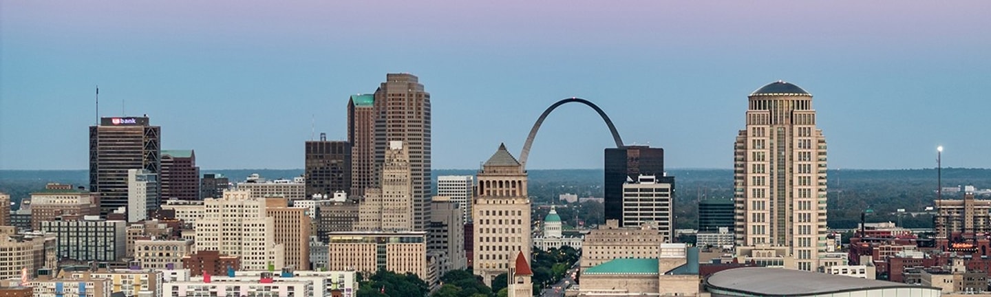 A city skyline featuring the Gateway Arch in St. Louis