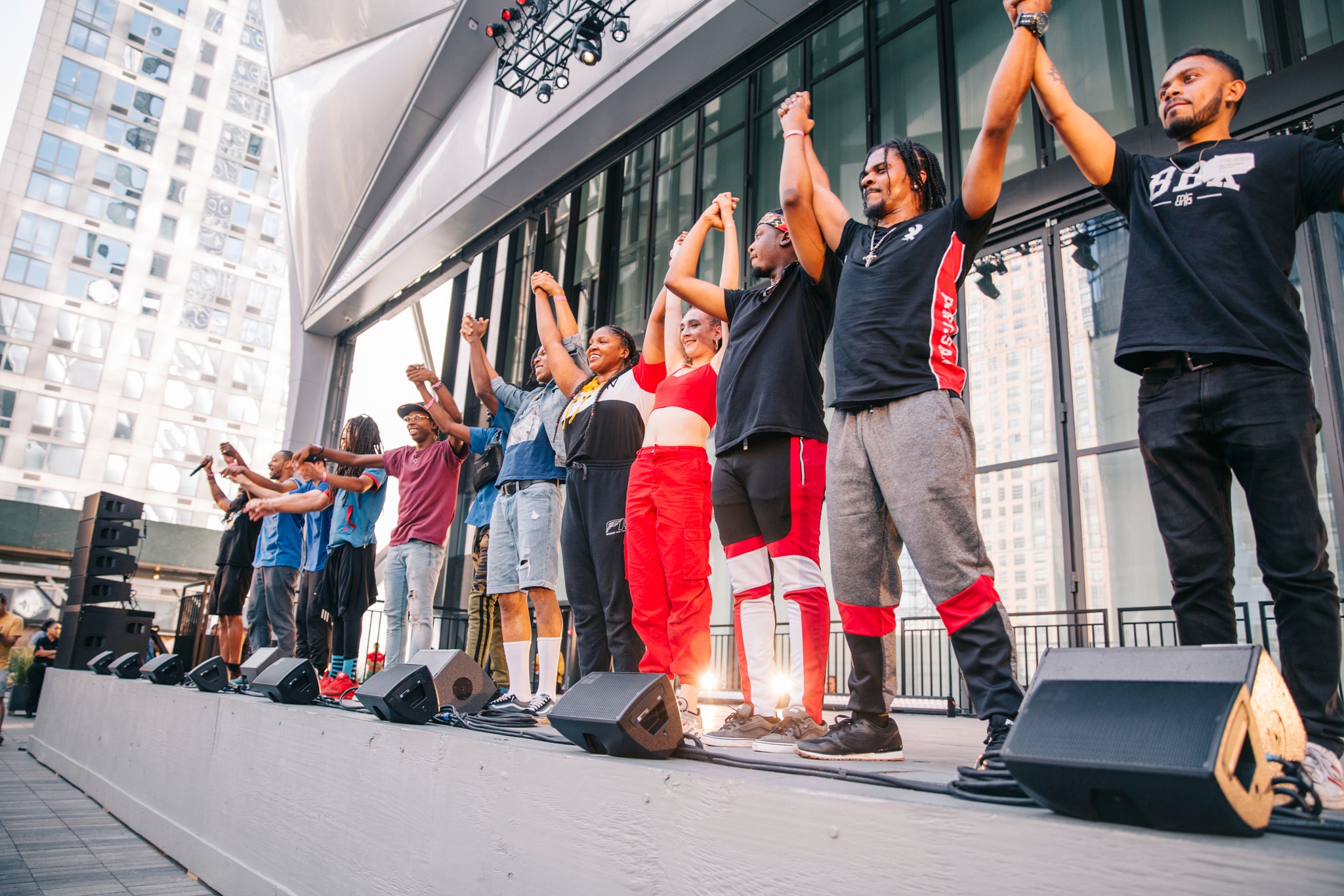 Performers taking a bow on stage to standing ovation.