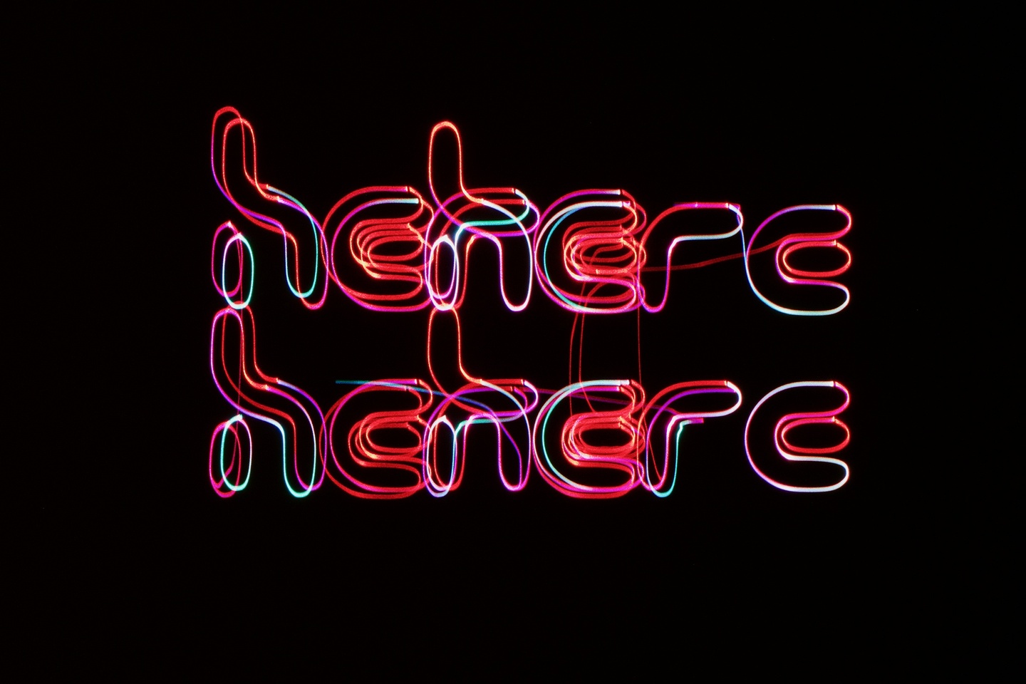 Red, purple, white laser lights in the shapes of letters and words