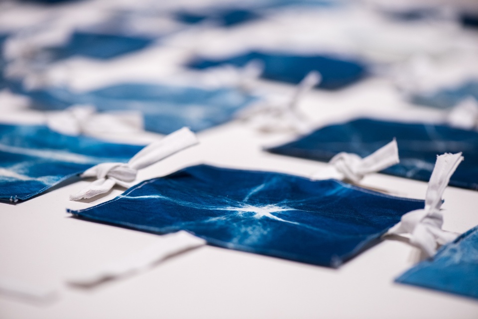 Detail shot of a grid arrangement of hand-dyed blue fabric squares.