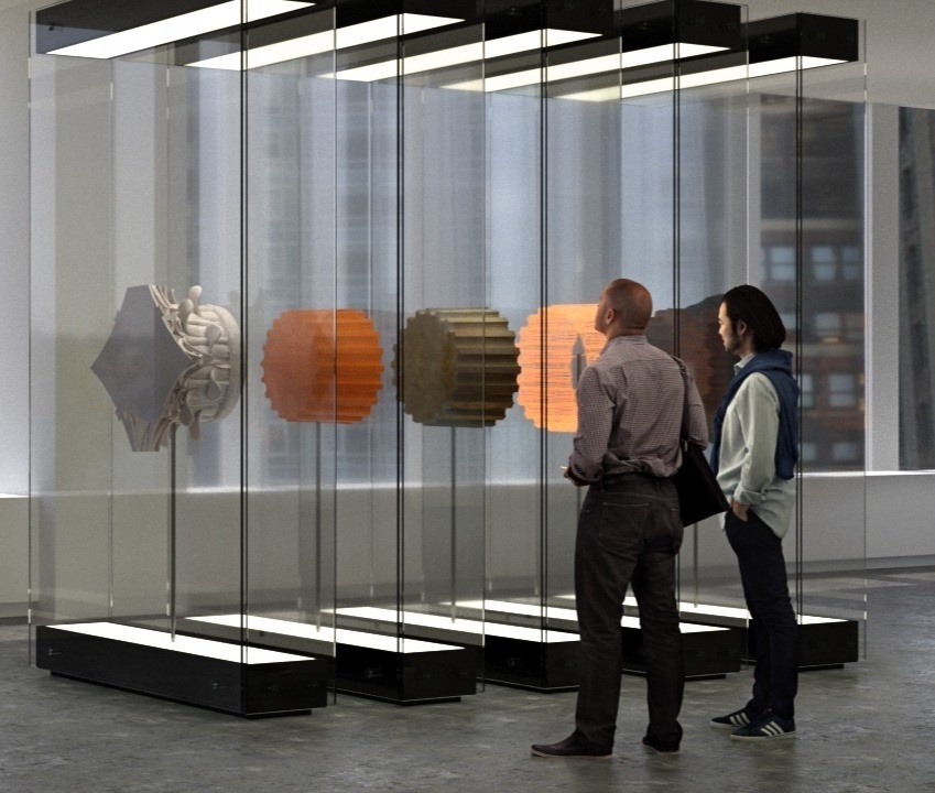 People standing in front of a series of glass vitrines with different train station artifacts