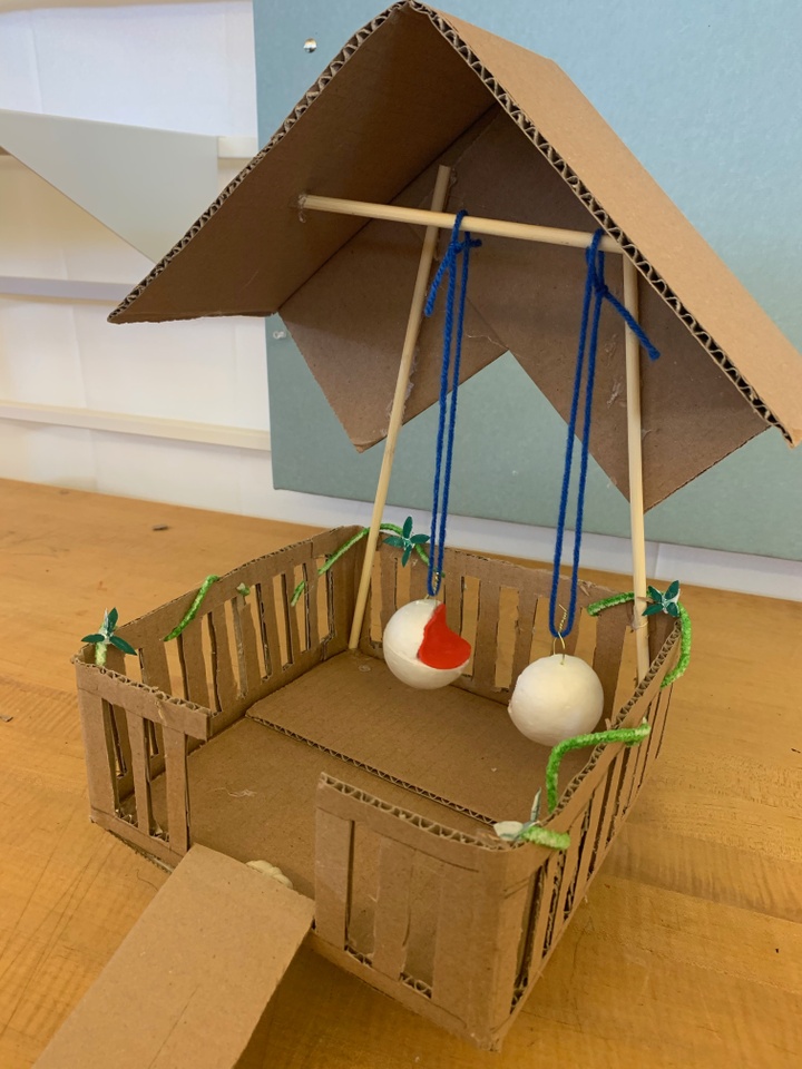 A model made out of cardboard, yarn, and other materials.