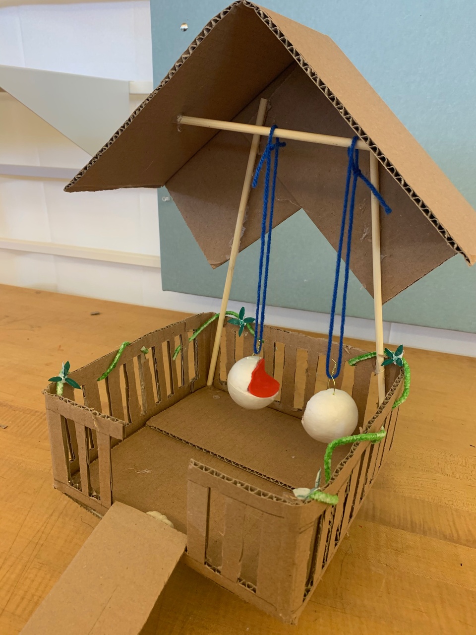 A model made out of cardboard, yarn, and other materials.