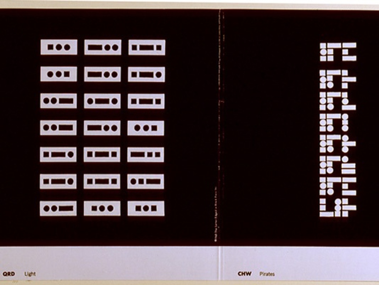 A series of dots and squares appearing as a code on a black background