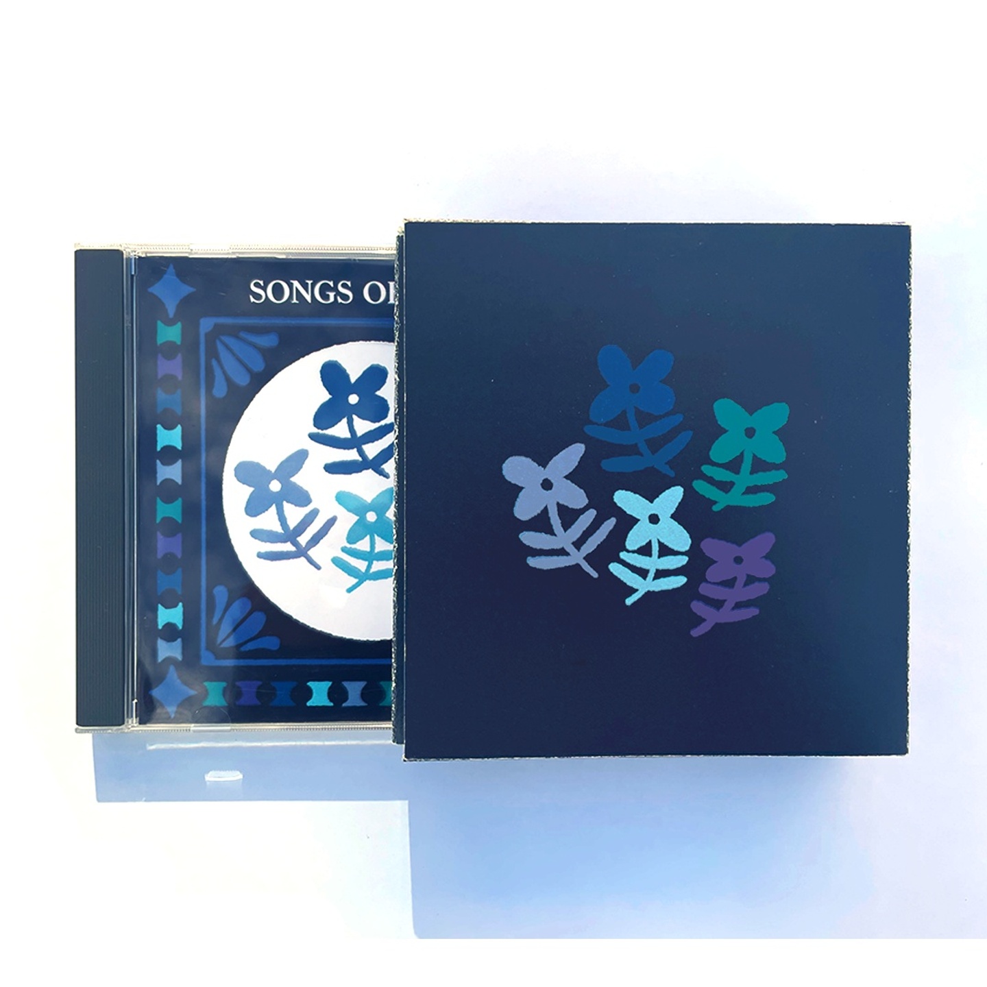 An illustrated blue CD cover and interior with flower motifs. 