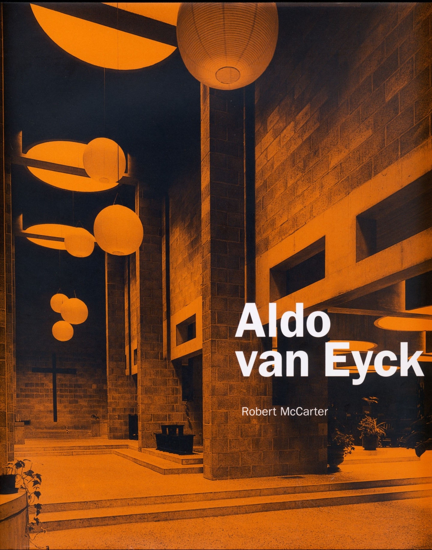 Cover of Aldo van Eyck, with a two-tone orange and black photo of the interior of a building with impressive columns and globe lights hanging down from the ceiling at different heights.