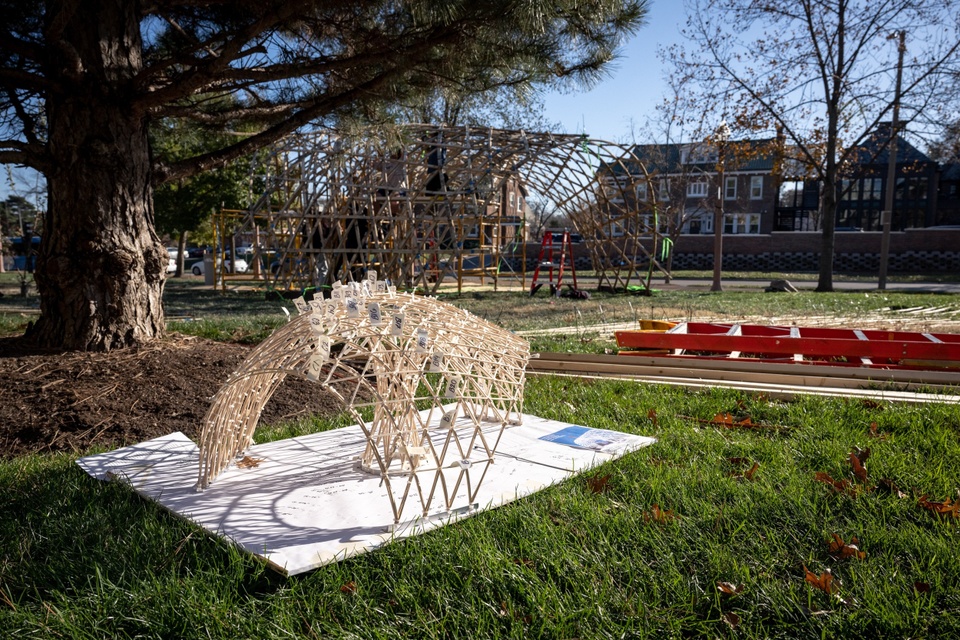 Architectural model in the foreground with its built structure in background.