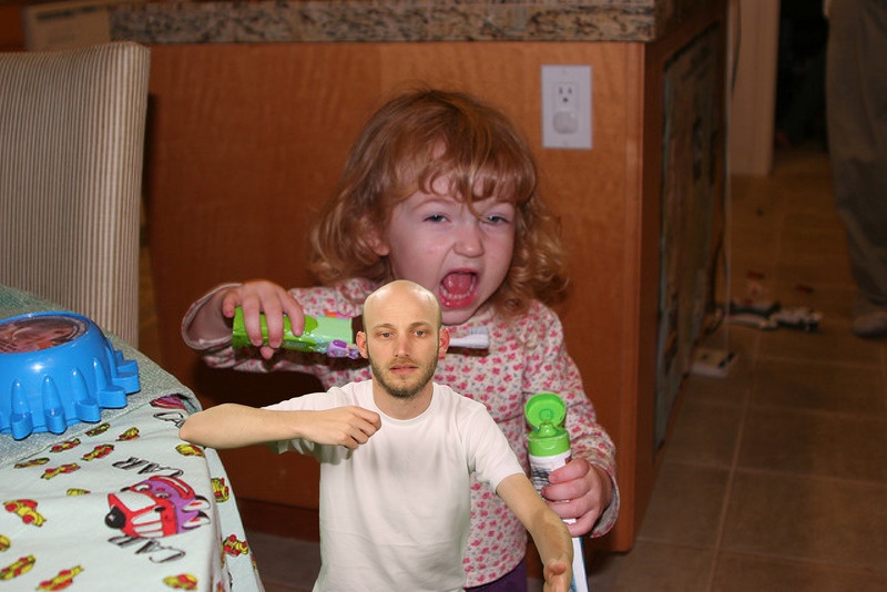 A photo from Sam Lavigne's Open Call commission Training Poses depicting A little girl preparing to brush her teeth