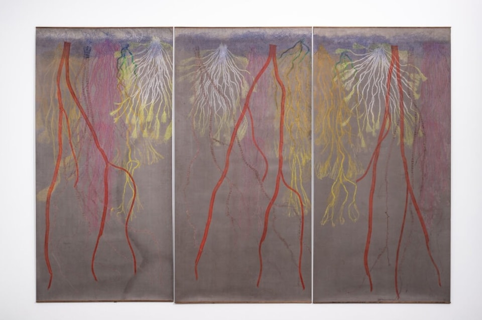 triptych of roots printed in reds, yellows, and oranges