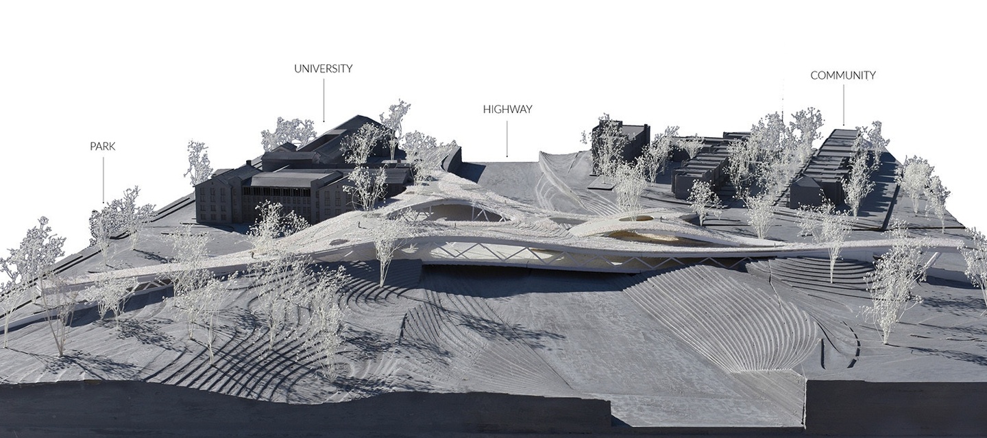 Image of a physical model of the neighborhood featuring a land "bridge" and labeled features such as a park, university, highway, and community.