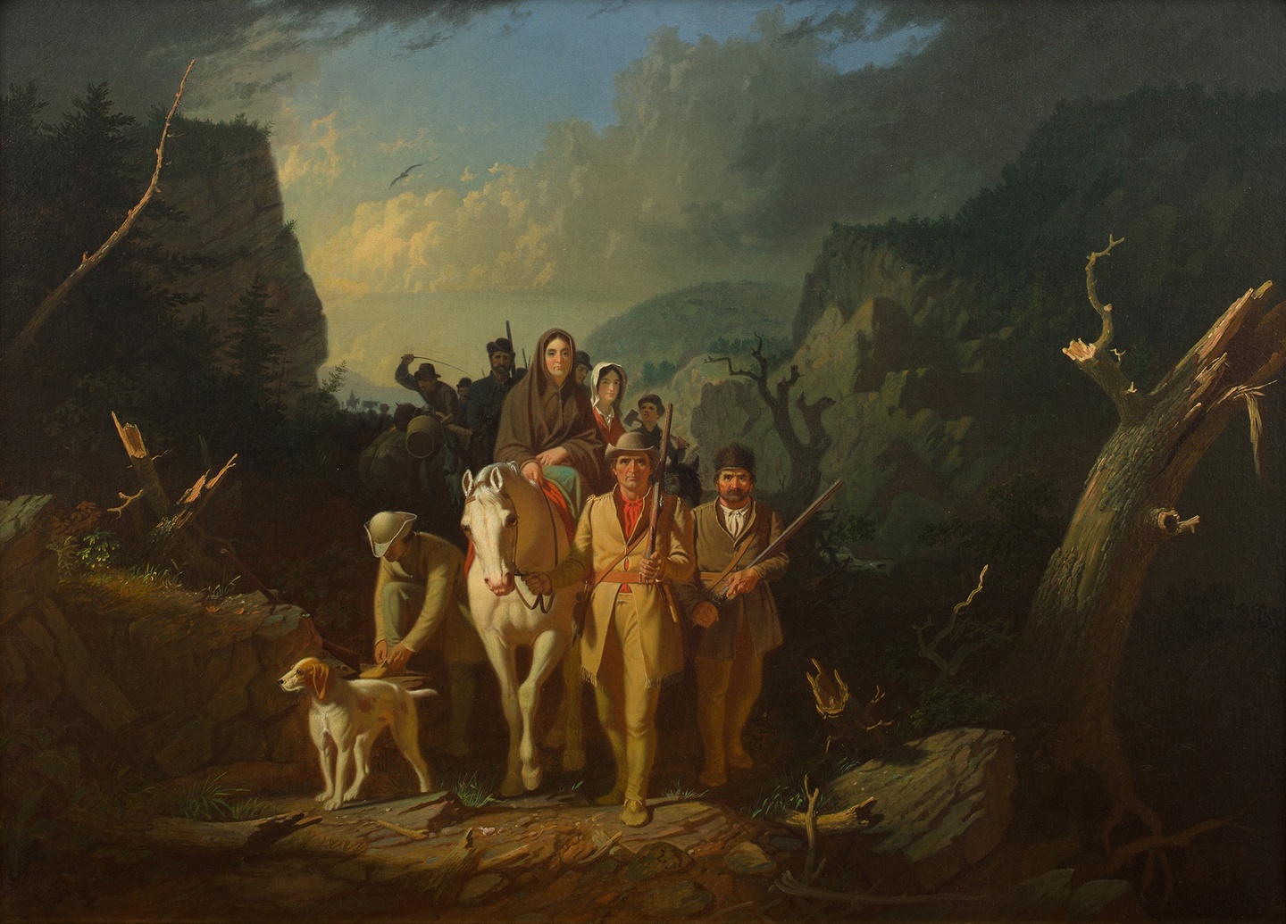 A group of people, some on horseback, walking through a mountain pass