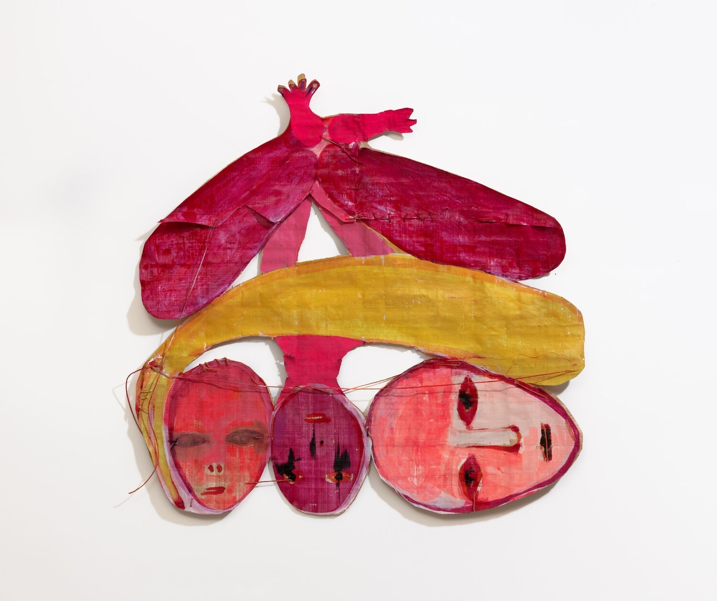 Mixed media painting in bright pinks, reds, and gold, featuring three heads at the bottom—one upright, one upside down, one sideways—under elongated shapes up top, made out of ink and thread on papyrus.