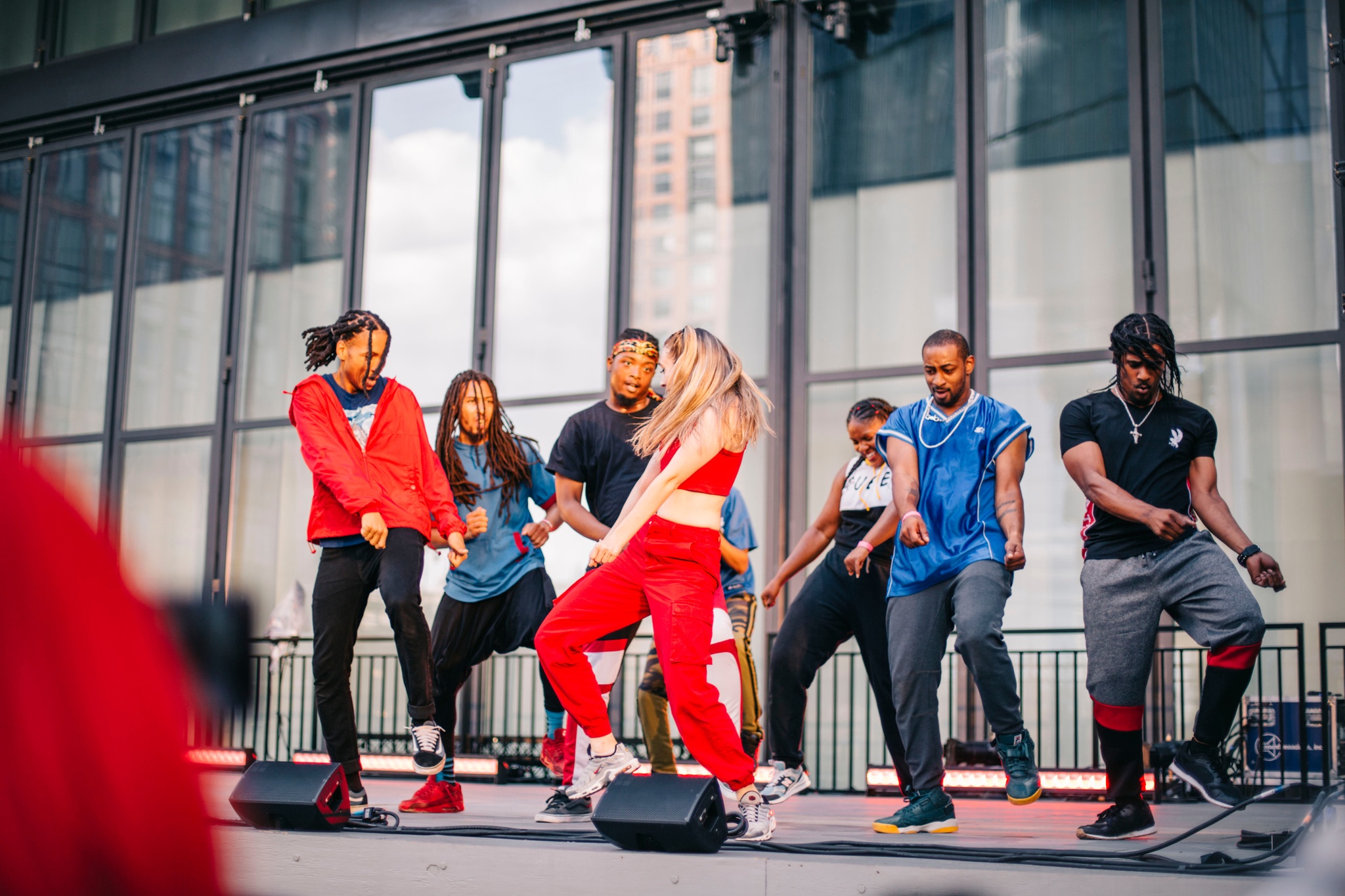 A group of dancers in motion on a stage.